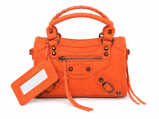 Orange studded moto tassel satchel handbag with suede-look finish, antique bronze hardware and top handles, front view.