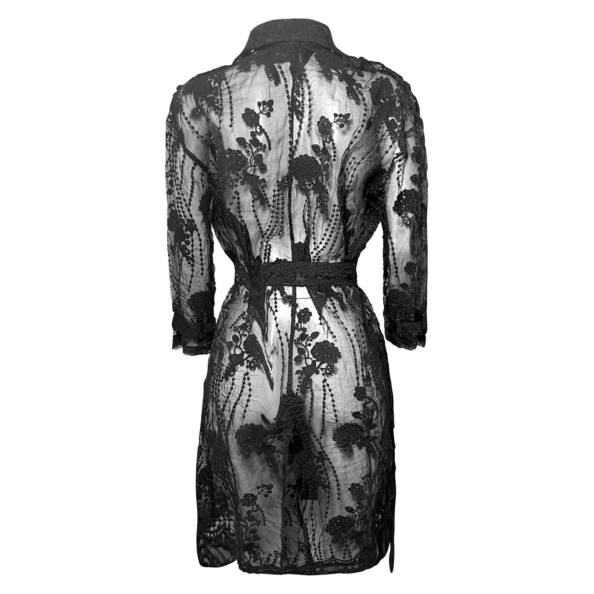 Back view of a black sheer lace trench coat with floral embroidery and belted waist. 